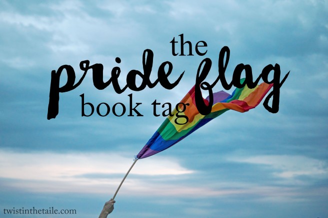 A hand holding up a rainbow pride flag over a clouded sky, with the words 'the pride flag book tag'.