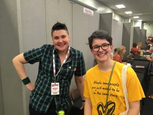 Eve and Non Pratt. Eve wears a yellow t shirt that reads 'maybe some people are just meant to be in the same story'.